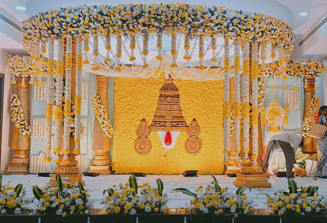 Traditional muhurtham wedding stage decoration with yellow floral theme in Hyderabad
