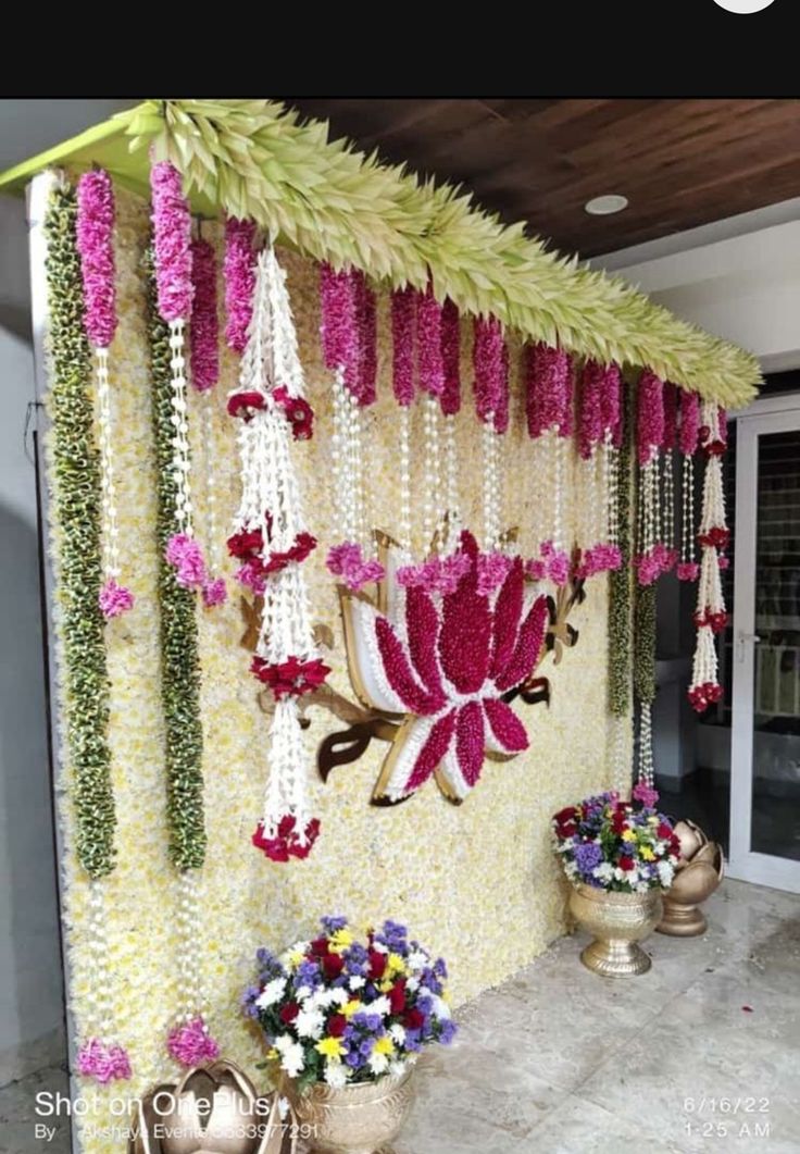 Beautiful floral haldi backdrop decoration with lotus design and hanging flower garlands for traditional events in Hyderabad.