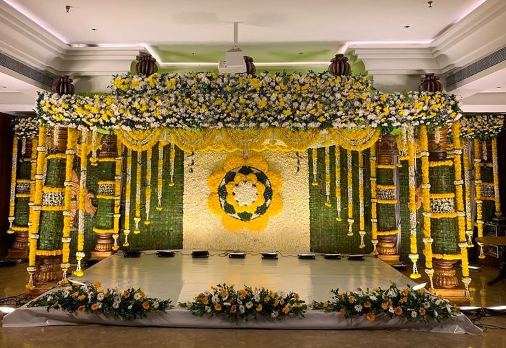 Haldi stage decoration with yellow floral hangings in Hyderabad
