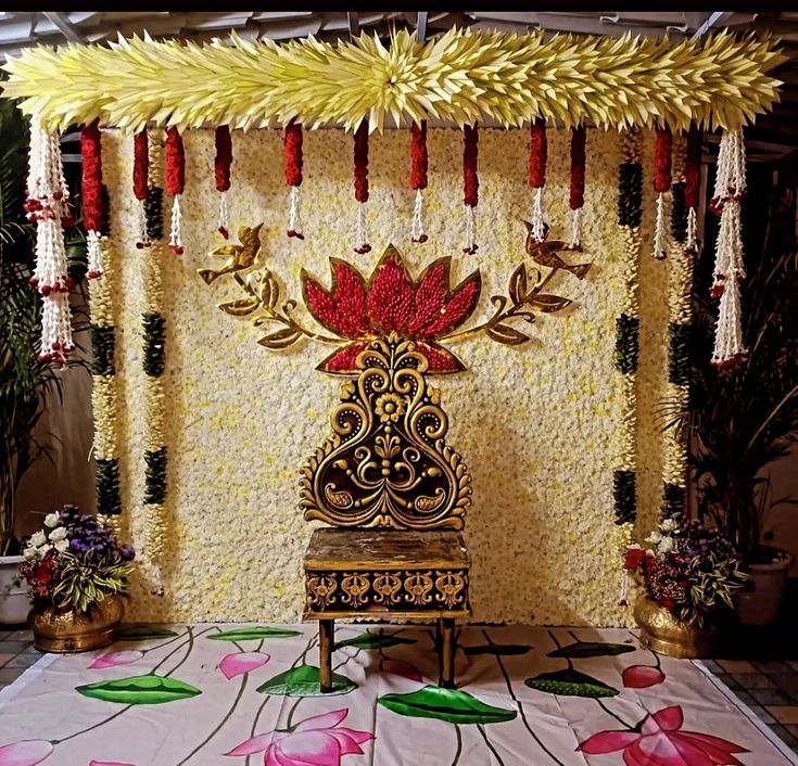 Elegant half saree function backdrop decoration with lotus floral wall and traditional hanging garlands in Hyderabad.