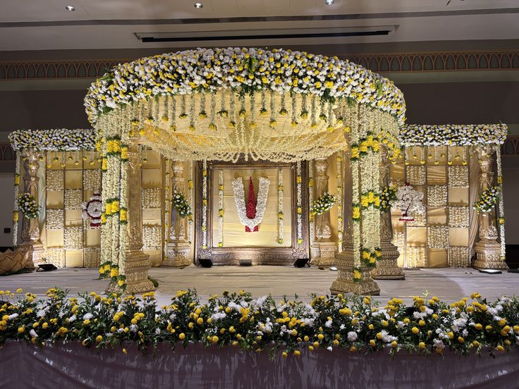 Elegant floral wedding mandap decoration with white and yellow flowers for traditional South Indian weddings in Hyderabad.