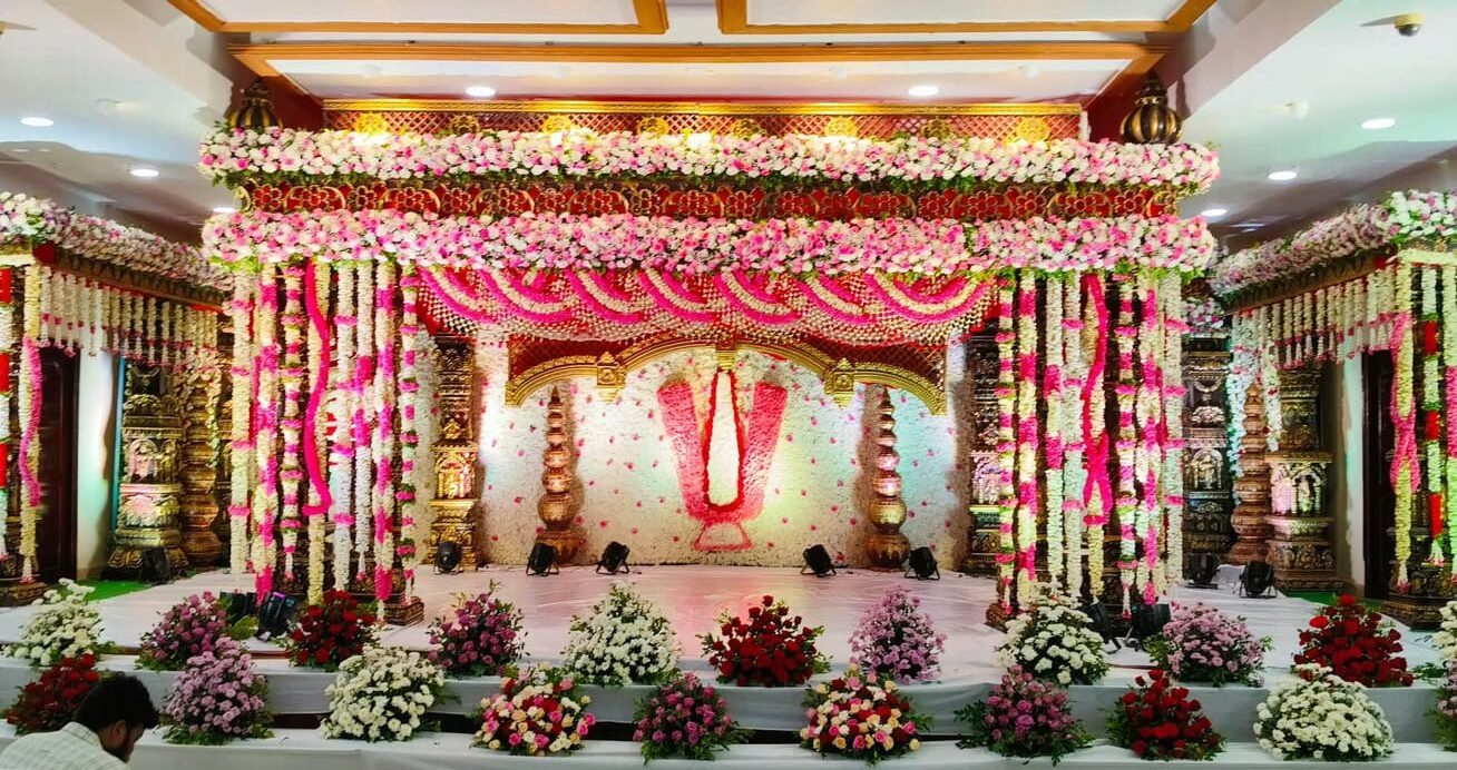 Elegant pink and white floral wedding mandap decoration with traditional temple-style setup in Hyderabad.